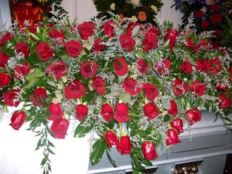 Casket spray of red roses from Bunn Flowers & Gifts, local florist in Pittsburg, TX