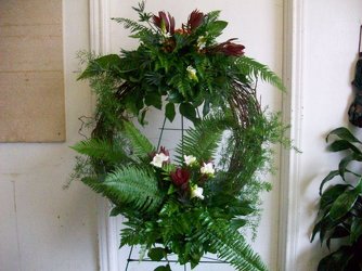 Grapevine wreath with fresh greenery and flowers on a stand from Bunn Flowers & Gifts, local florist in Pittsburg, TX